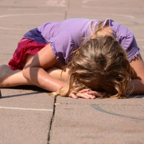 Girl on floor outside, crying